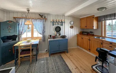 a kitchen with a table and a small table and a tableablish at 3 Bedroom Lovely Home In Sjusjøen in Sjusjøen