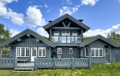 a gray house with a fence in front of it at Stunning Home In Beitostølen With Sauna in Beitostøl