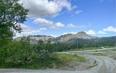 a winding road with mountains in the background at Stunning Home In Beitostølen With Sauna in Beitostøl