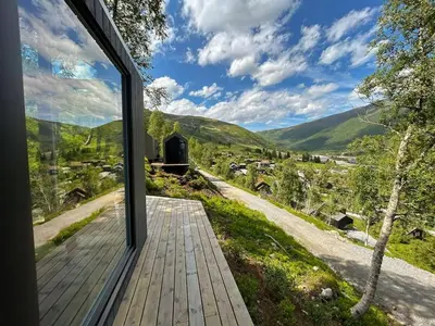 a door to a house with a view of a valley at Tiny Mountain Cabin I in Stranda