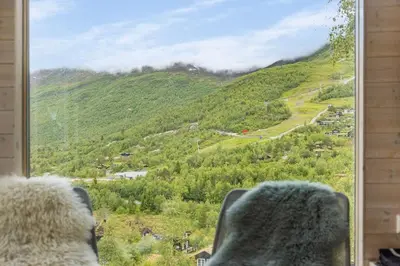 a view of a mountain from a window at Tiny Mountain Cabin II in Stranda