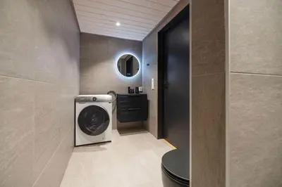 a bathroom with a washer and dryer in a room at Mountain View Apartment - 102 in Stranda