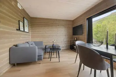 a living room with a table and chairs at Mountain View Apartment - 102 in Stranda