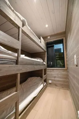two bunk beds in a room with a window at Mountain View Apartment - 102 in Stranda