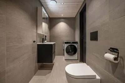a bathroom with a washing machine and a toilet at Mountain View Apartment - 205 in Stranda