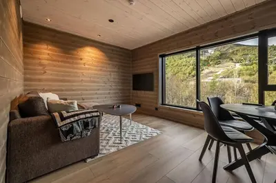 a living room with a couch and a table at Mountain View Apartment - 205 in Stranda