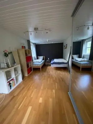 a large living room with a hard wood floor at Hus med plass til 7 personer til leie in Veka