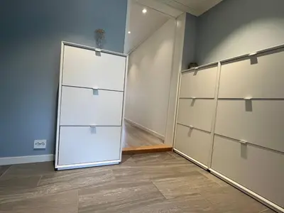 a room with a large white closet with a door at Sunny gateaway Room in Lerstad, Suitable for two guests in Ålesund