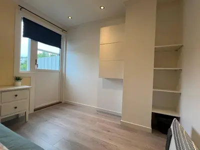an empty room with a bed and a window at Cozy Urban Single Room in Ålesund
