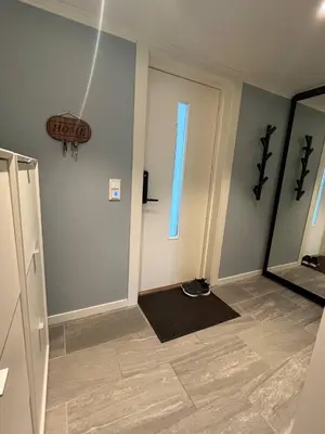 a hallway with a door and a window and a mirror at Cozy Urban Single Room in Ålesund