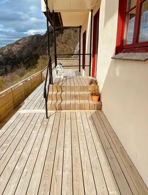 a cat sitting on the stairs of a house at Unique apartment with fantastic views in Bergen