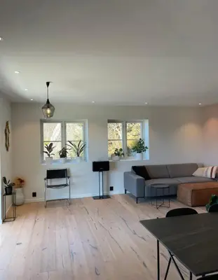 a living room with a couch and a table at Unique apartment with fantastic views in Bergen
