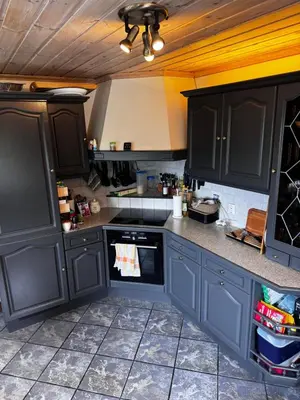 a kitchen with dark blue cabinets and an oven at Villa with a view in Morviki