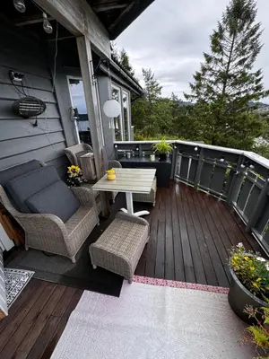 a patio with a table and chairs on a deck at Villa with a view in Morviki