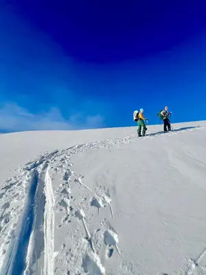 two people standing on top of a snow covered slope at Stryn Golden Resort - Panorama I in Stryn