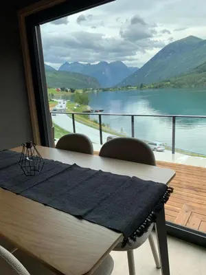 a dining room table with a view of a lake at Stryn Golden Resort - Panorama II in Stryn