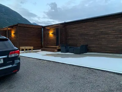 a car parked in a parking lot in front of a building at Stryn Golden Resort - Panorama II in Stryn