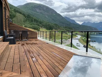 a wooden deck with a view of a mountain at Stryn Golden Resort - Panorama II in Stryn