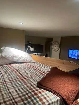 a bedroom with a bed and a tv on the wall at Ålesund sentrum Parkgata in Ålesund