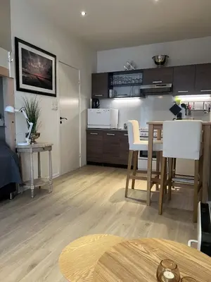a kitchen and living room with a table and chairs at Ålesund sentrum Parkgata in Ålesund