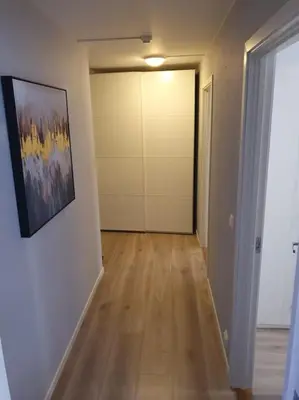 a room with a hallway with a painting on the wall at Corner apartment with 2 bedrooms in the middle of the city centre in Trondheim
