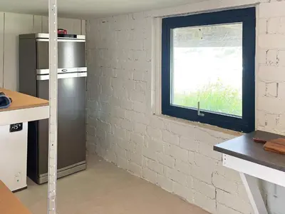 a kitchen with a refrigerator and a window at 6 person holiday home in BØMLO in Bømlo
