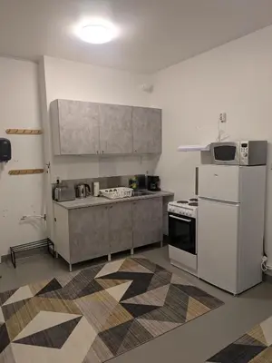 a kitchen with a white refrigerator and a stove at Liten leilighet midt i sentrum in Stryn