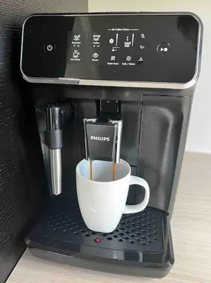 a coffee cup is being brewed in a coffee machine at Nytt hus i fredfullt nabolag in Verdal