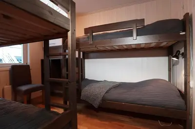 a bedroom with two bunk beds and a chair at Hemsedal, Ski in Ski out, Skarsnuten Panorama 55 in Tuv