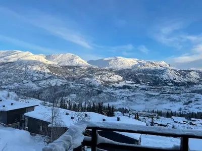 a view of a snowy mountain range with snow covered mountains at Hemsedal, Ski in Ski out, Skarsnuten Panorama 55 in Tuv