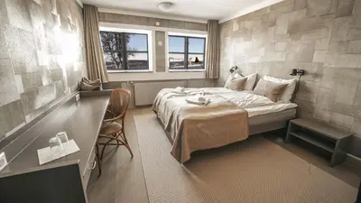 a hotel room with a bed and a window at Danebu Kongsgaard - Boutique Hotel in Aurdal