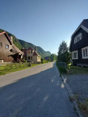 an empty street in a village with houses at Old Town House in Rjukan