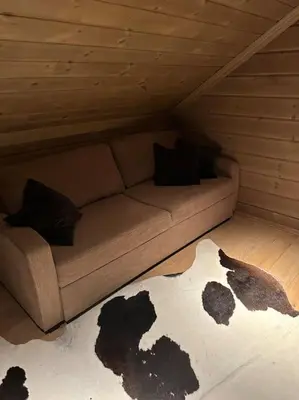 a room with a couch in a attic at Myrkdalen Lodge II, luxury family cabin ski in and out in Helgatun