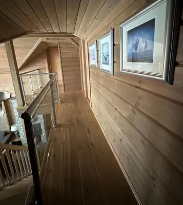 a wooden staircase in a house with a picture on the wall at Myrkdalen Lodge II, luxury family cabin ski in and out in Helgatun