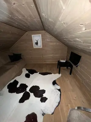 a room with a bed with cows on it at Myrkdalen Lodge II, luxury family cabin ski in and out in Helgatun