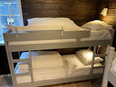 a bunk bed in a room with two beds at Cozy apt with a view in Beitostøl