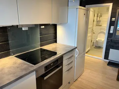 a kitchen with a sink and a stove top oven at Cozy apt with a view in Beitostøl