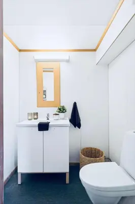 a white bathroom with a toilet and a sink at Leilighet med særpreg in Lillehammer
