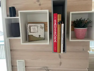 a book shelf with books on it with books at Modern, lovely holidayhome, in quiet nature close to Trolltunga in Utsikten