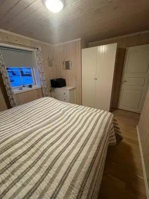 a small bedroom with a bed and a window at Modern, lovely holidayhome, in quiet nature close to Trolltunga in Utsikten
