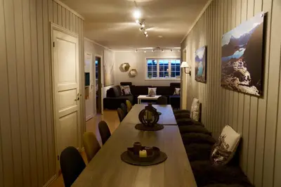 a living room with a table and a couch at Ideal For Families And Groups Near Ski Slopes And Amenities in Beitostøl