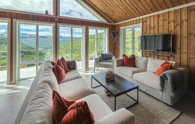 a living room with couches and a flat screen tv at Awesome Home In Norheimsund With Wifi in Norheimsund