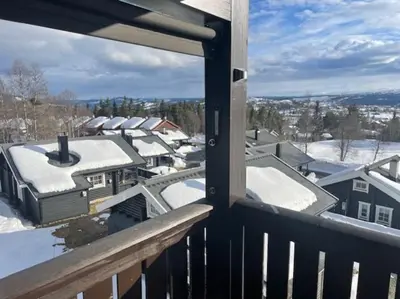 a balcony with snow on the roofs of houses at Fjellparken 351 in Beitostøl