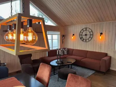 a living room with a couch and a table at Hytte Gaustablikk in Gaustablikk