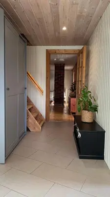 a hallway of a house with a door and a potted plant at Shelby's Home in Heimstad