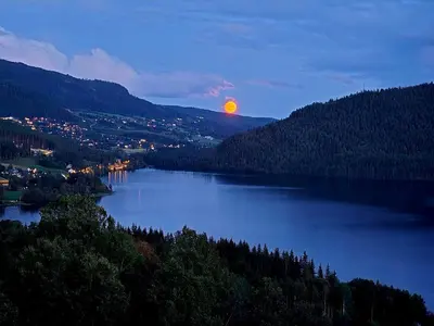 a view of a lake at night with the moon at Knobelauch Family Home, Valdres in Vøle