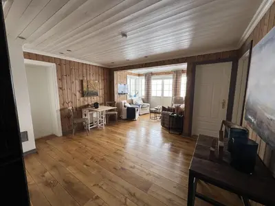 a living room with wooden walls and a wooden floor at Cozy Apartment With Stunning Mountain Views in Beitostøl
