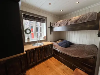 a bedroom with two bunk beds and a window at Cozy Apartment With Stunning Mountain Views in Beitostøl