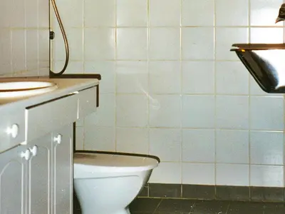 a bathroom with a toilet and a sink at 15 person holiday home in Flatanger-By Traum in Straum