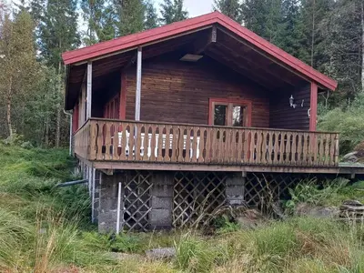 a log cabin with a deck on a hill at 7 person holiday home in Skjold-By Traum in Skjold